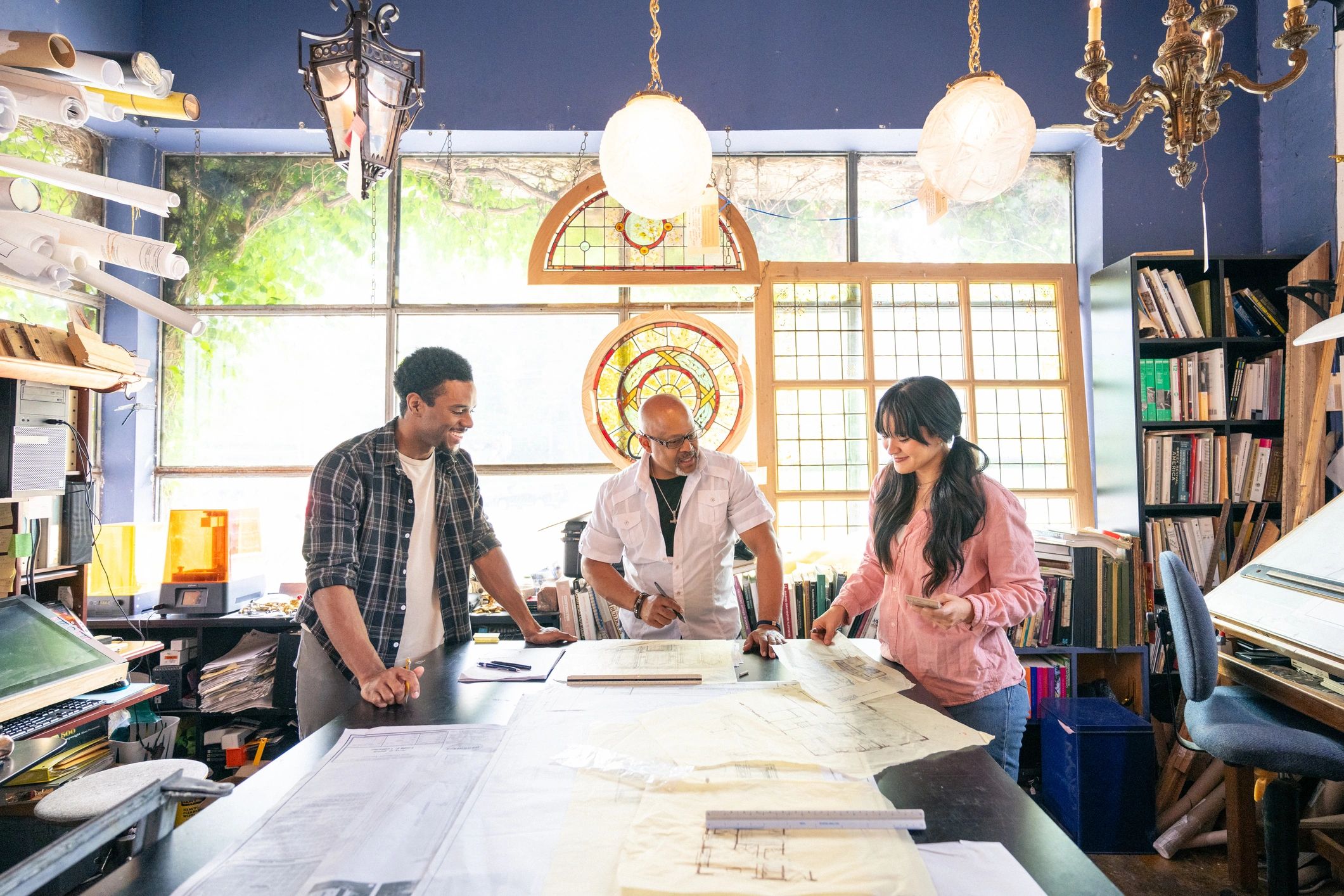 Construction project team reviewing plans in a studio
