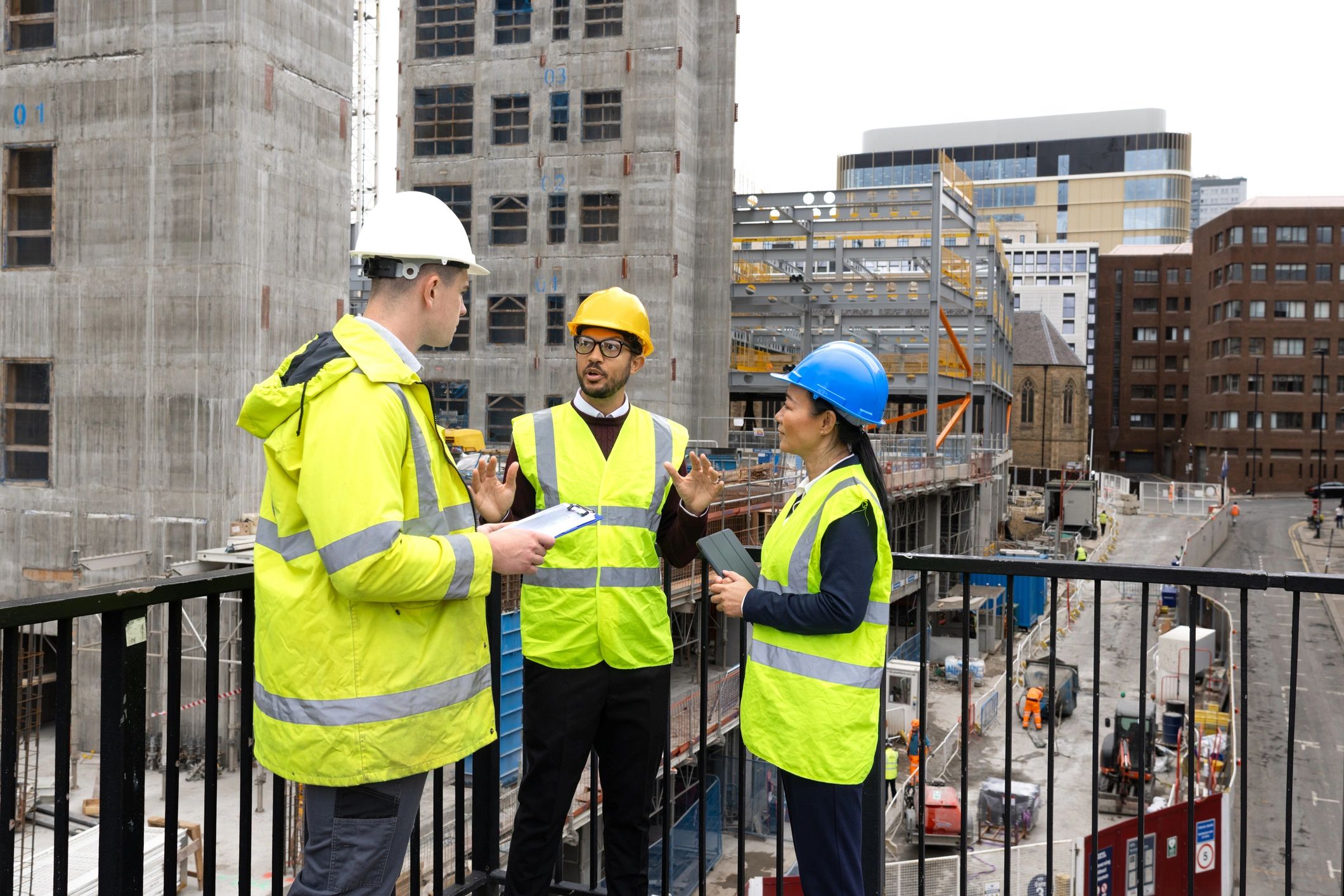 Construction professionals reviewing plans at a site