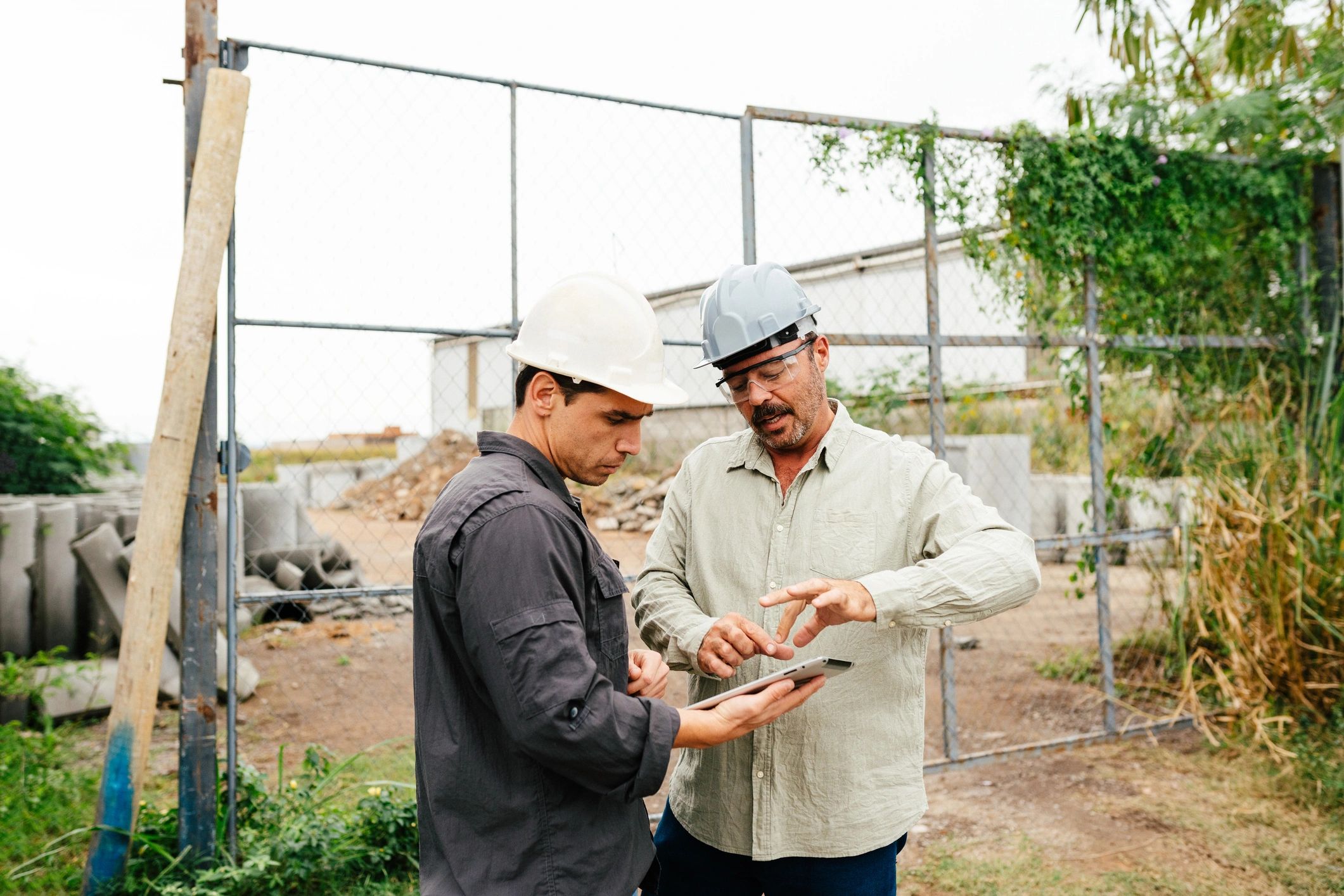 Workers reviewing operational information on a tablet